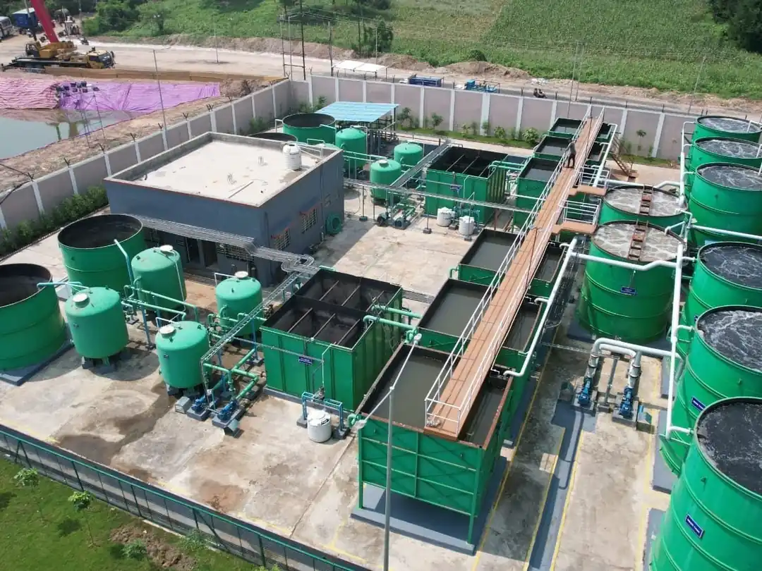 Aerial view of an SBS sewage treatment plant with green process tanks, tube settlers and treated water storage