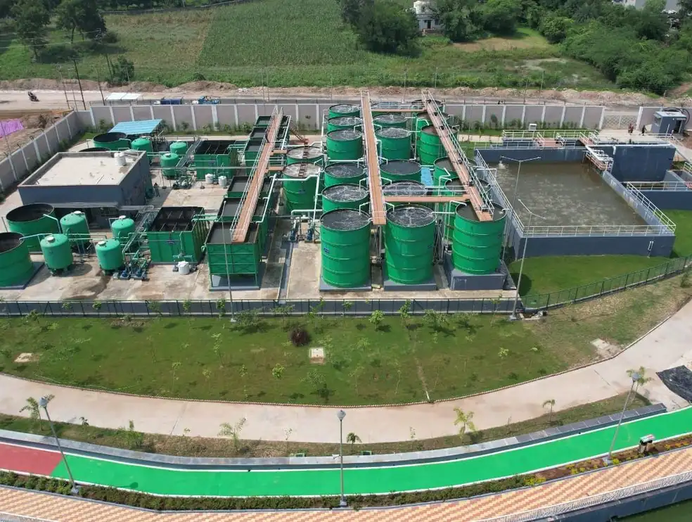 Aerial view of the sewage treatment plant built by SBS Water at Dahod, Gujarat, with green process tanks and a treated-water tank